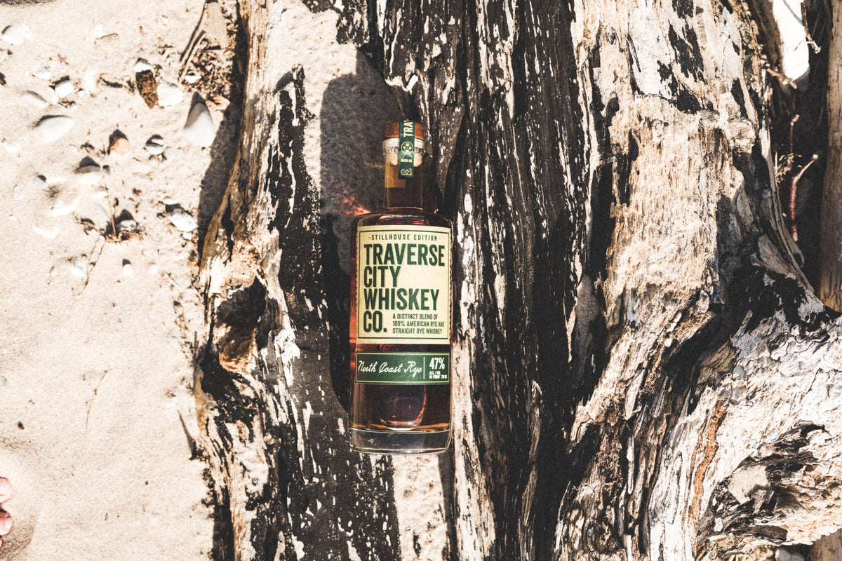 North Coast Rye bottle on driftwood in the sand
