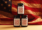 Three jars of Premium Cocktail Cherries in front of an American flag