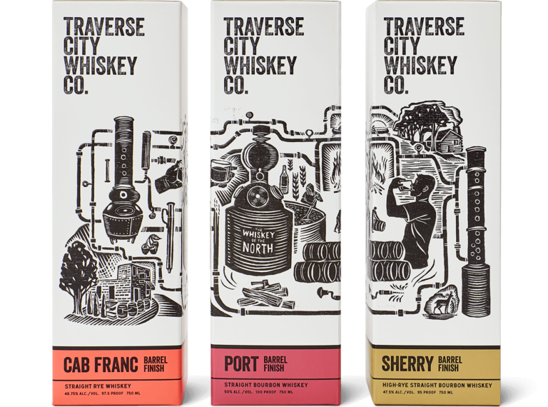 Three tall product boxes for Traverse City Whiskey Co. whiskey finishes arranged side by side on a light gray background.