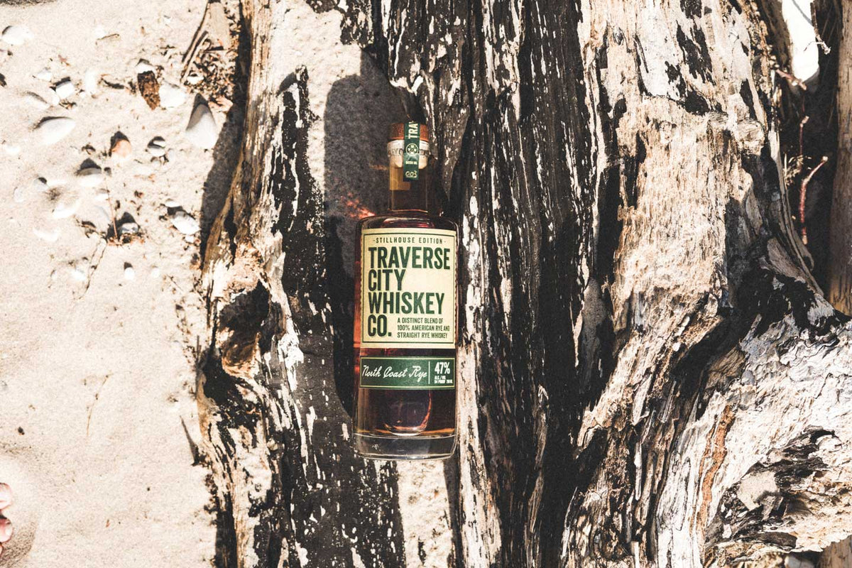North Coast Rye bottle on driftwood in the sand