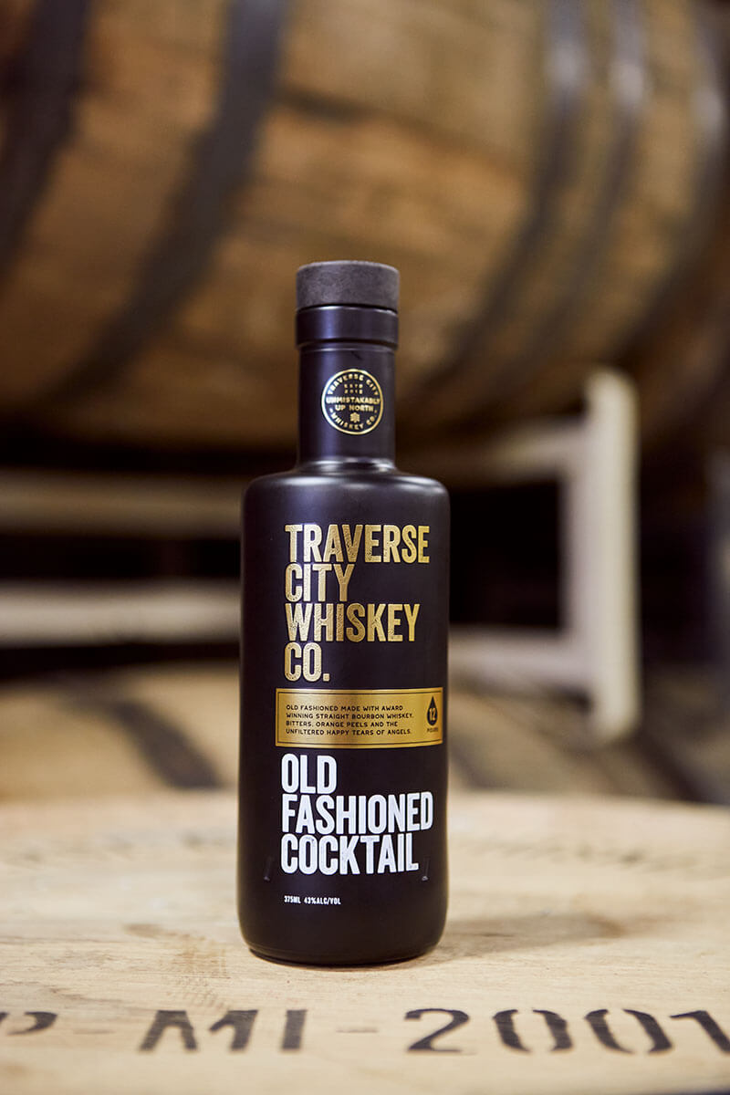 Ready-to-Serve Premium 6yr Old Fashioned bottle on a barrel
