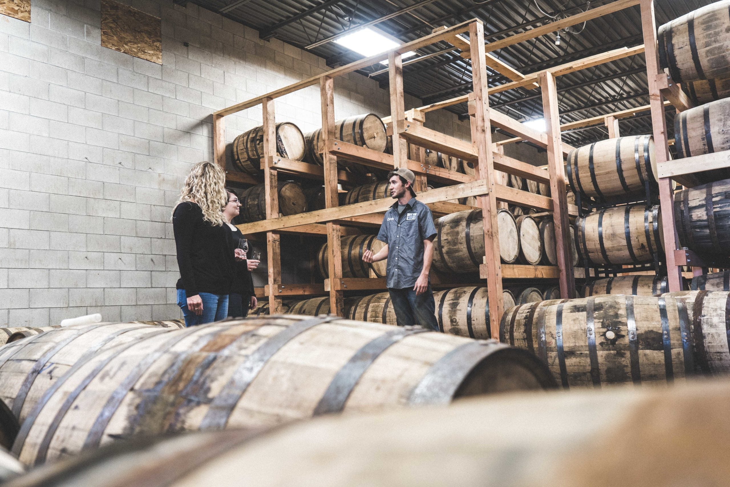 Guests exploring the barrel warehouse on a production tour