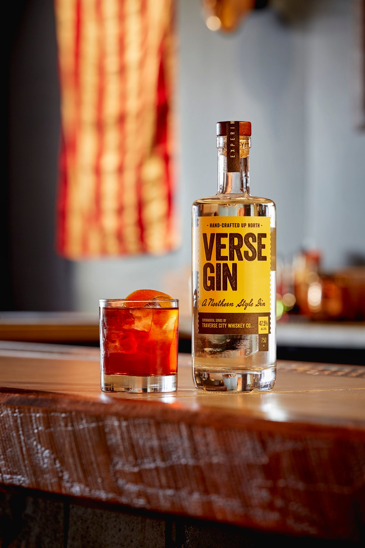 Verse Gin bottle with a Negroni cocktail