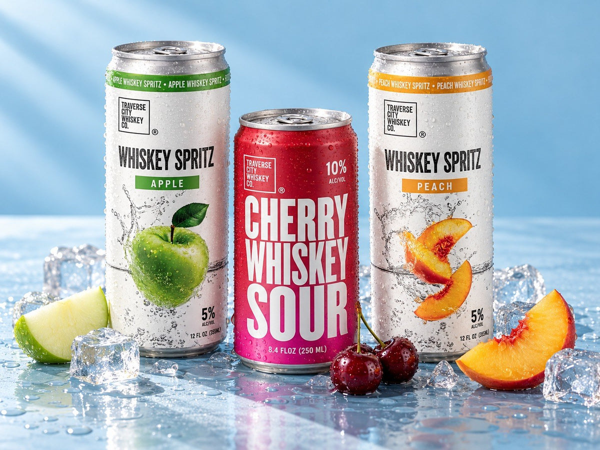 Whiskey Spritz Apple, Cherry Whiskey Sour and Whiskey Spritz Peach cans on ice